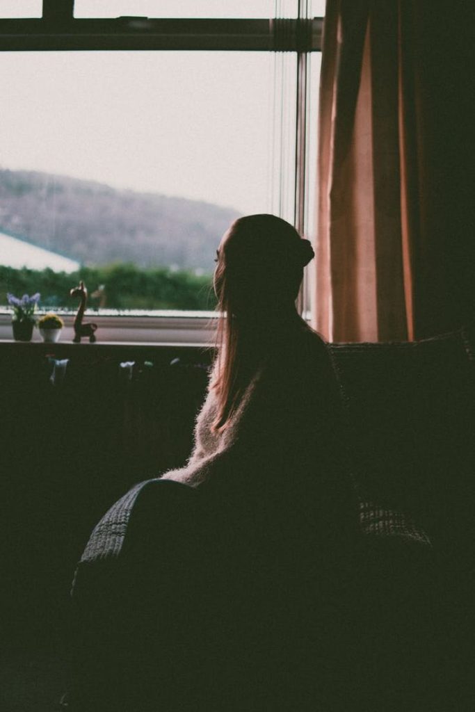 girl smiling looking out window