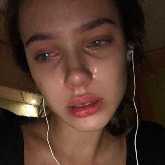 girl with headphones crying