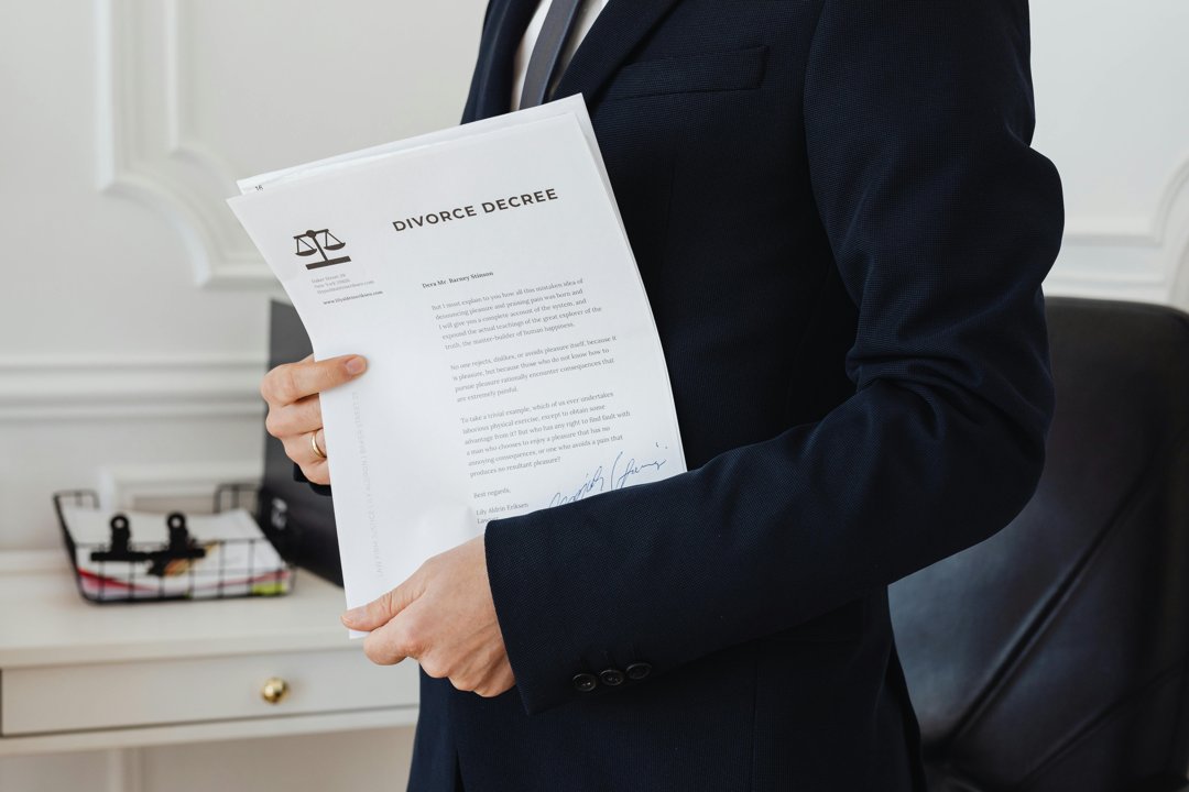 A woman holding divorce papers | Source: Pexels