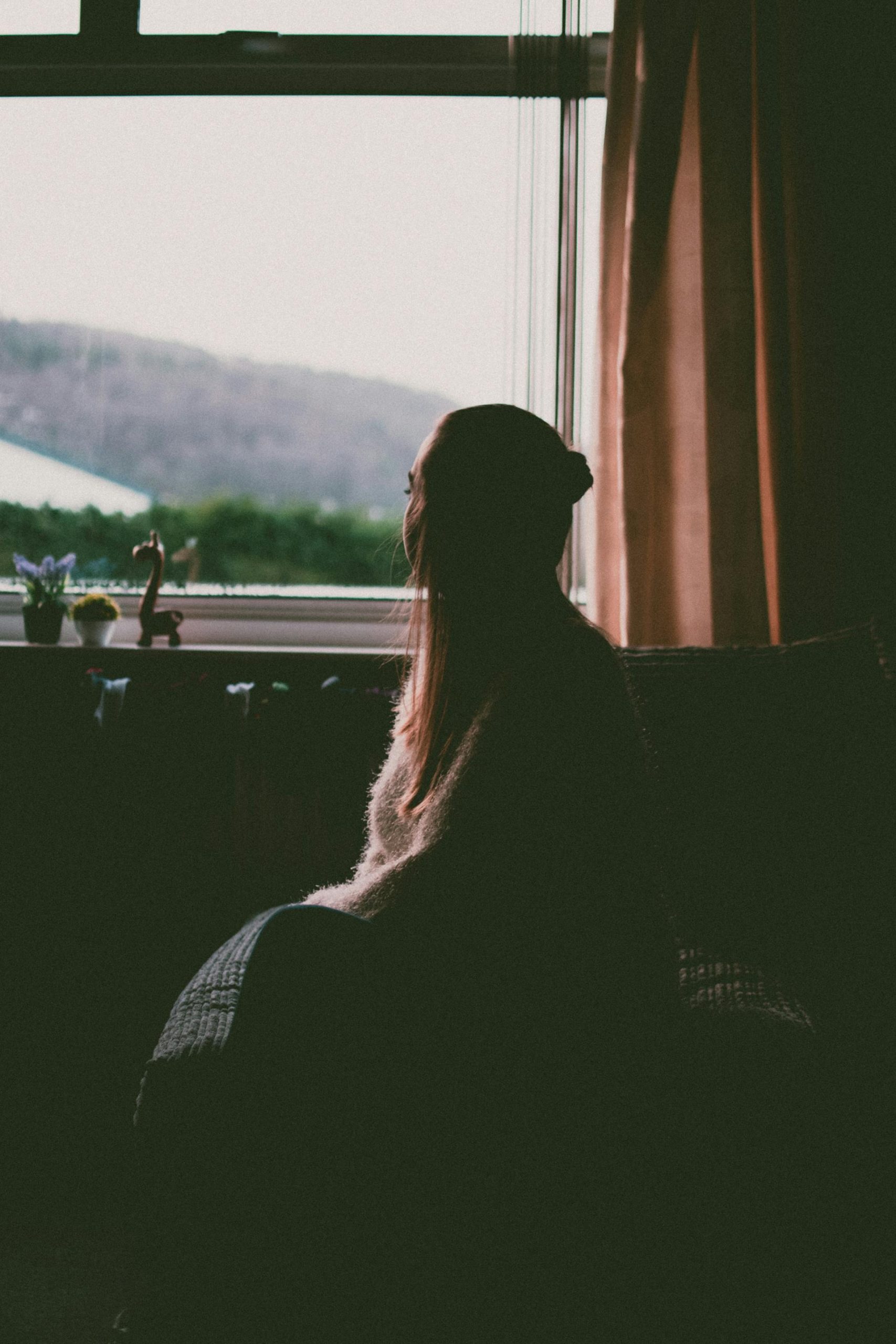 A woman sitting by the window | Source: Pexels