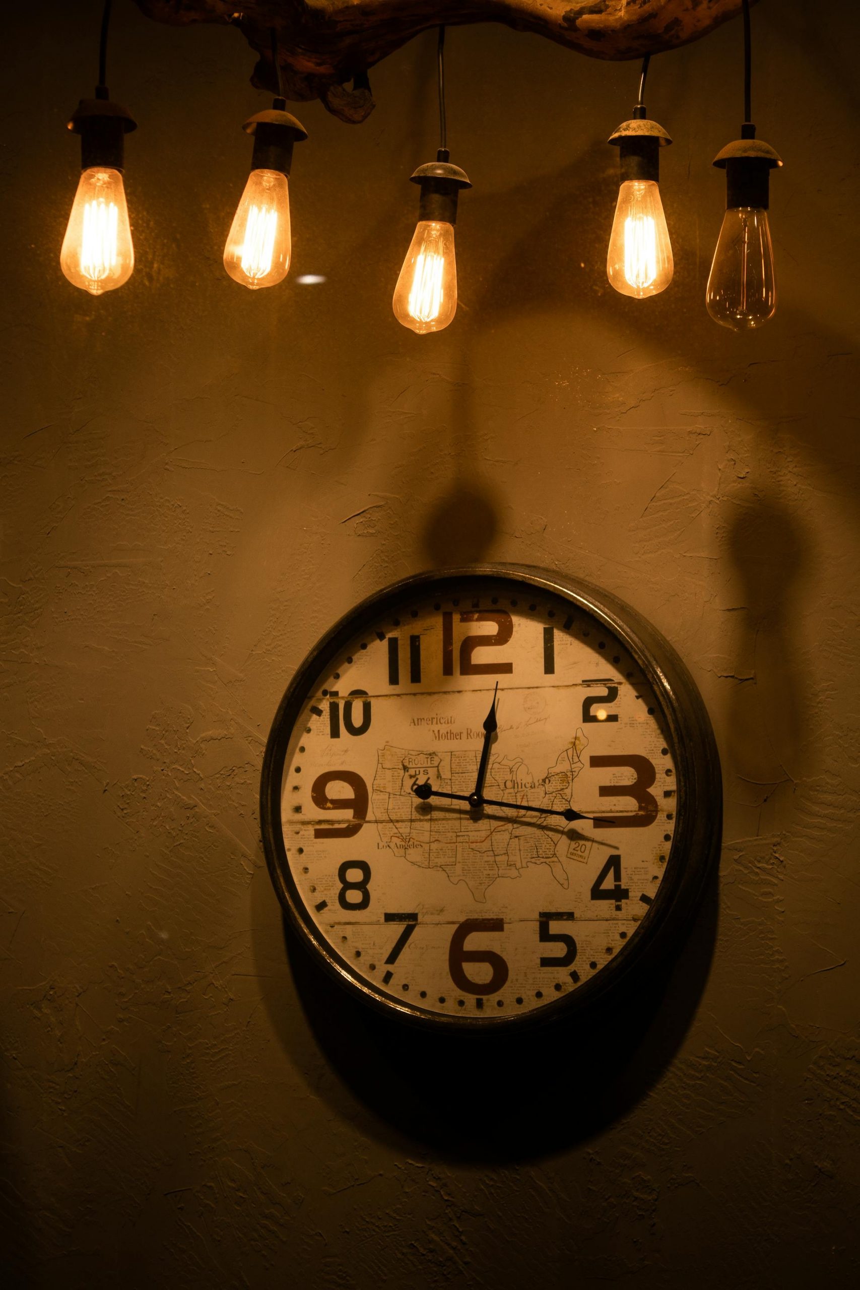 Light bulbs hanging over an analog clock | Source: Pexels