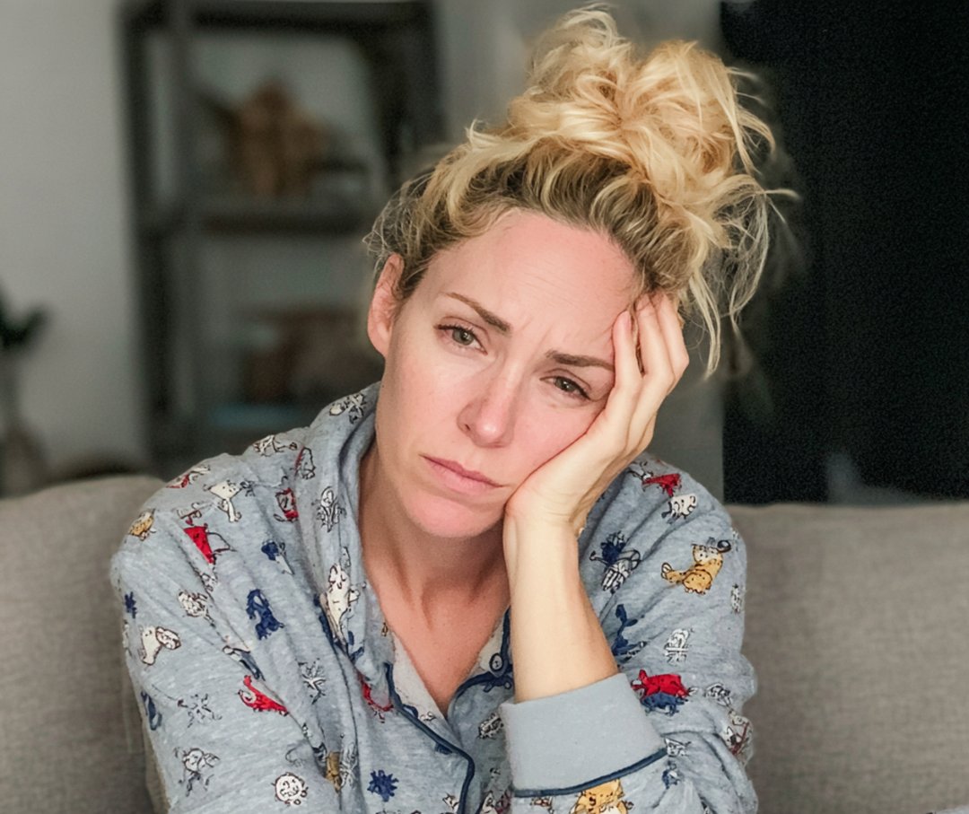An emotional woman wearing pajamas | Source: Midjourney