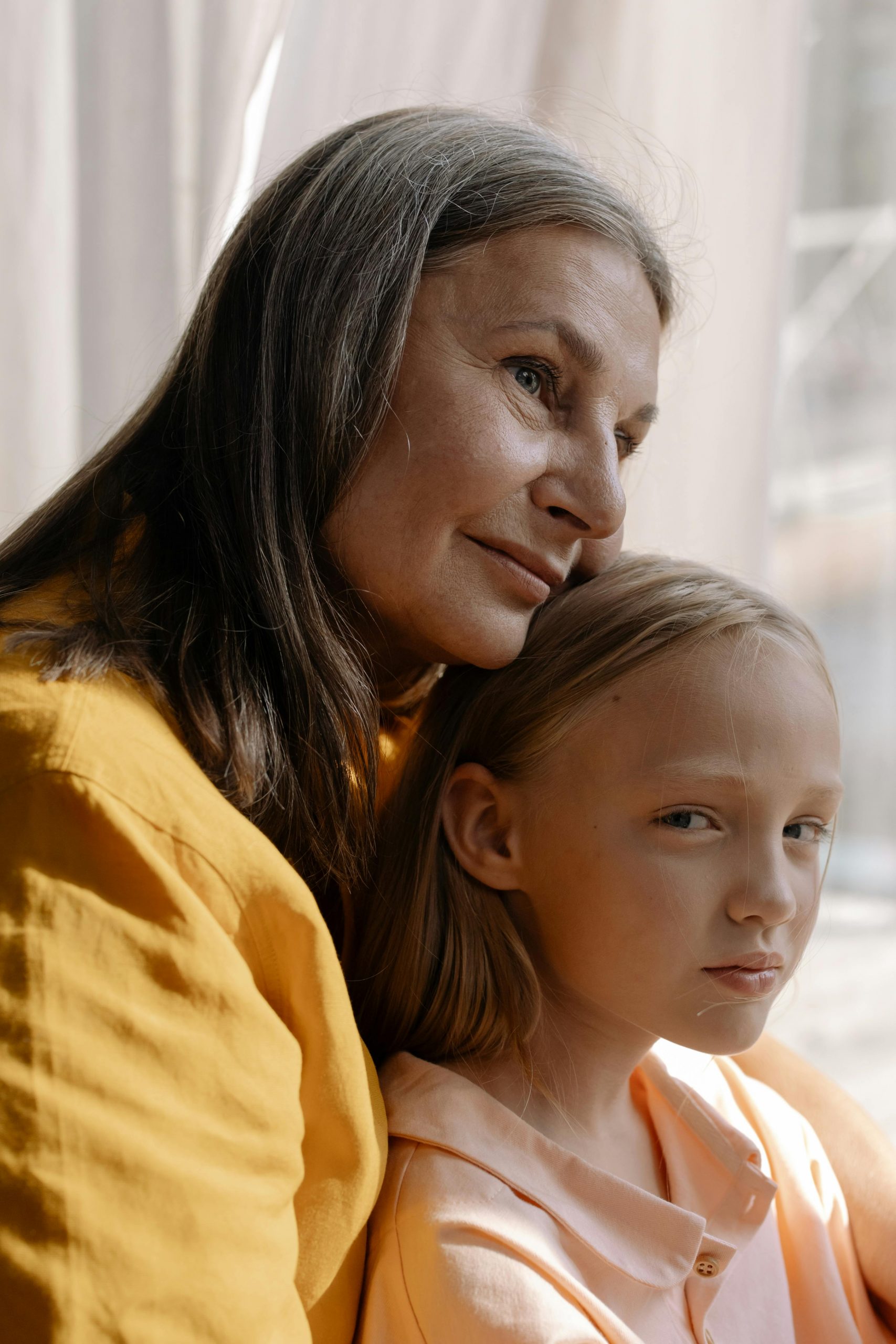 A grandmother hugging her granddaughter | Source: Pexels