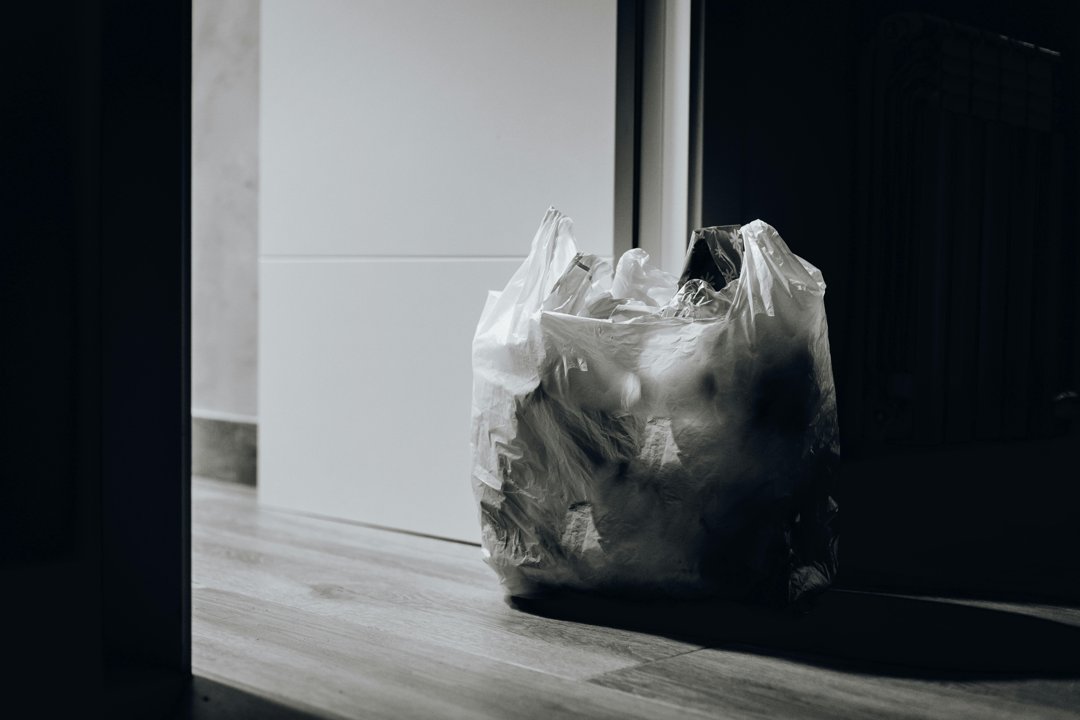 A bag of trash near a door | Source: Pexels