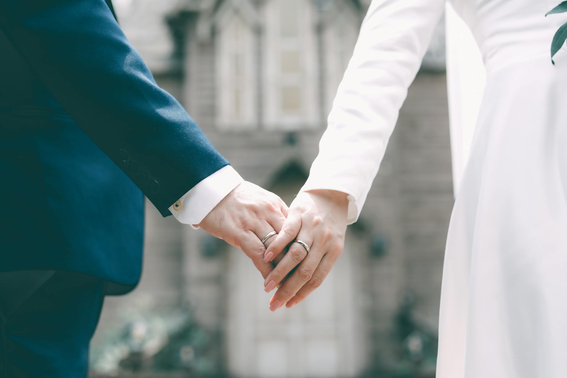 A couple holding hands on their big day | Source: Pexels