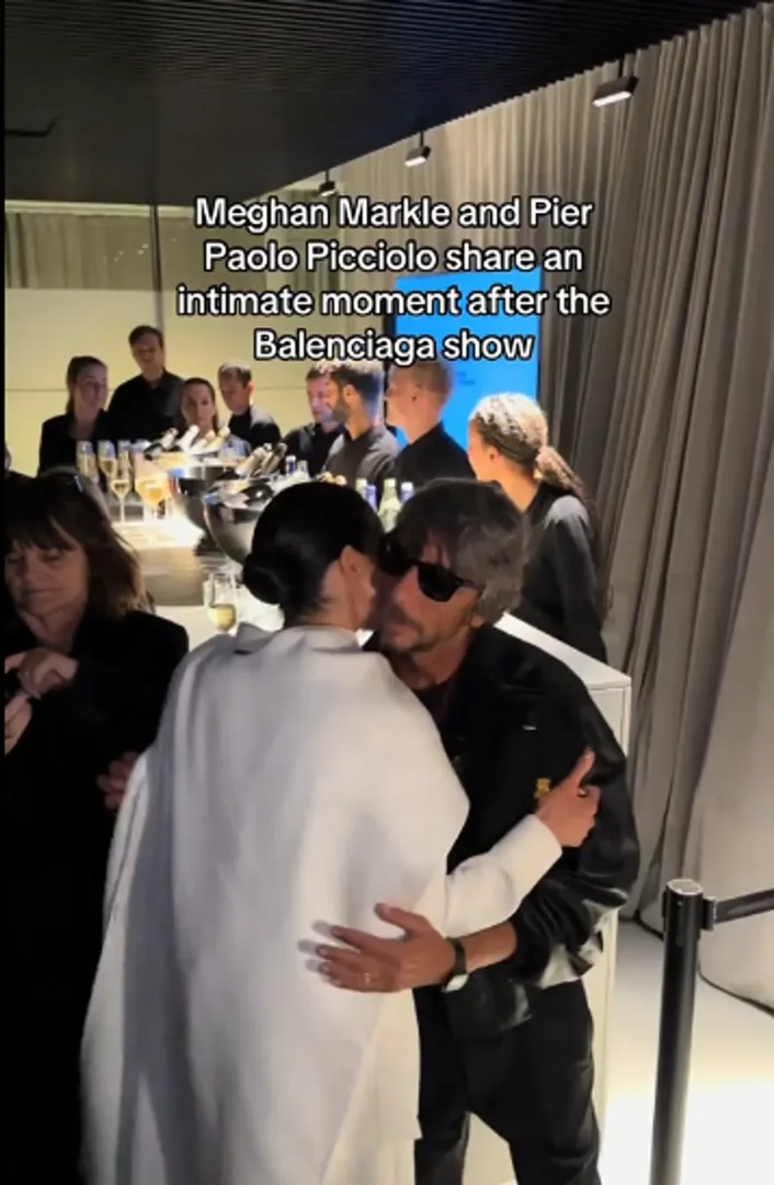 Meghan Markle and designer Pierpaolo Piccioli greet each other with a kiss and a casual embrace at Paris Fashion Week on October 4, 2025. | Source: TikTok/saintleon