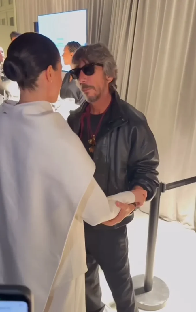 Meghan Markle and designer Pierpaolo Piccioli talking and touching at Paris Fashion Week. Source: Instagram/wwd
