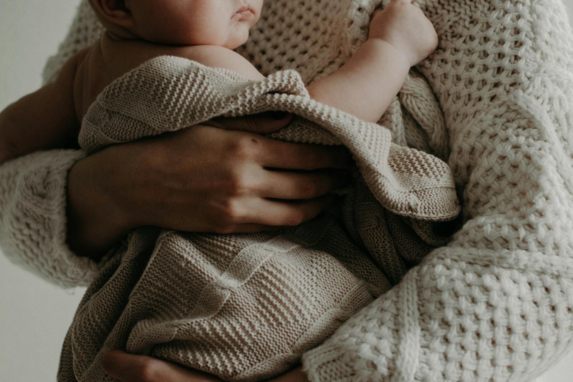 A woman holding her baby | Source: Pexels