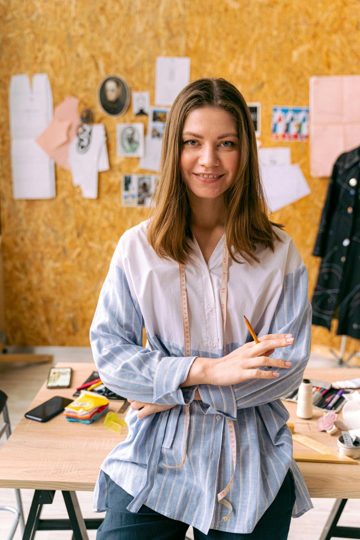 A woman smiling while getting ready to sew | Source: Pexels