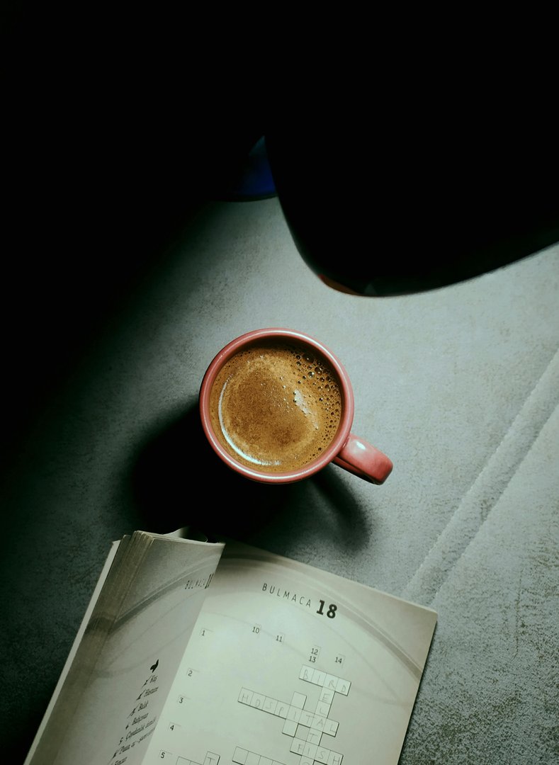 A crossword puzzle book and a cup of coffee | Source: Pexels