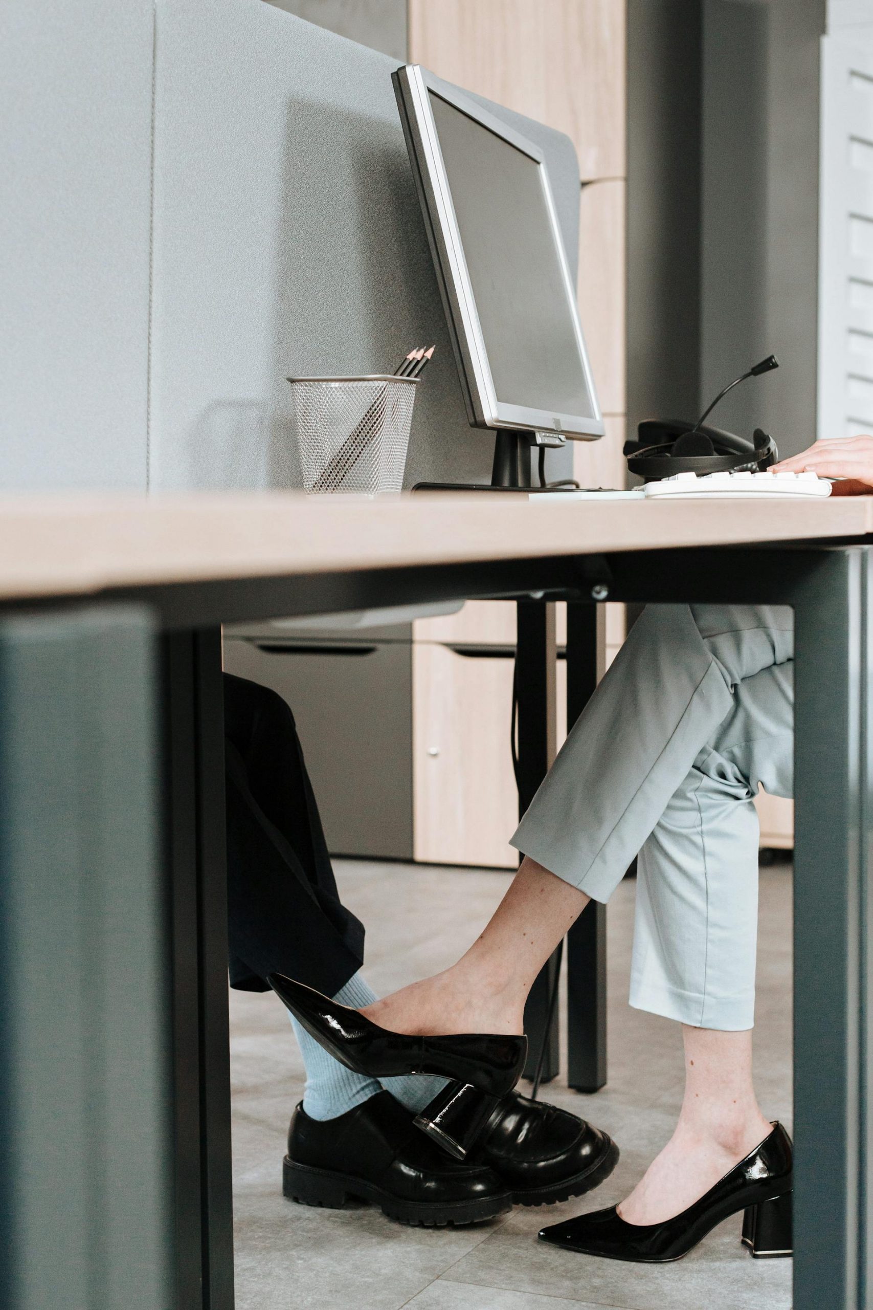 Colleagues flirting under the desk | Source: Pexels
