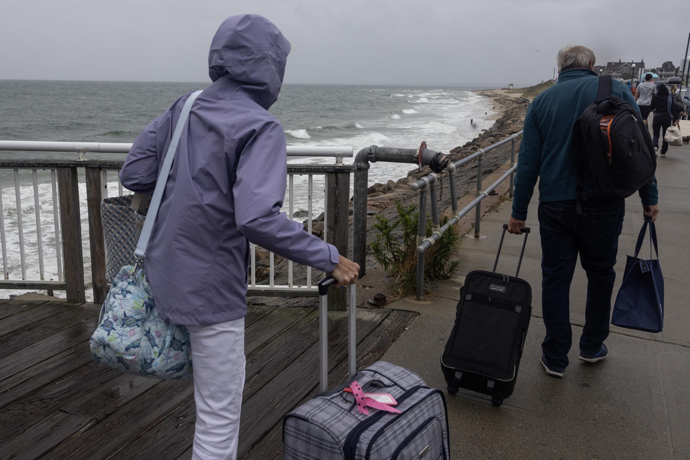 Passengers leave the last ferry in Oak Bluffs, Massachusetts, on August 20, 2025, ahead of Hurricane Erin's expected impacts along the New England coast | Source: Getty Images