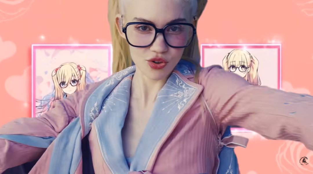 Grimes performs against an anime-inspired backdrop in her music video Artificial Angels, wearing oversized glasses and a pastel satin robe, as posted on October 21, 2025 | Source: YouTube/grimes