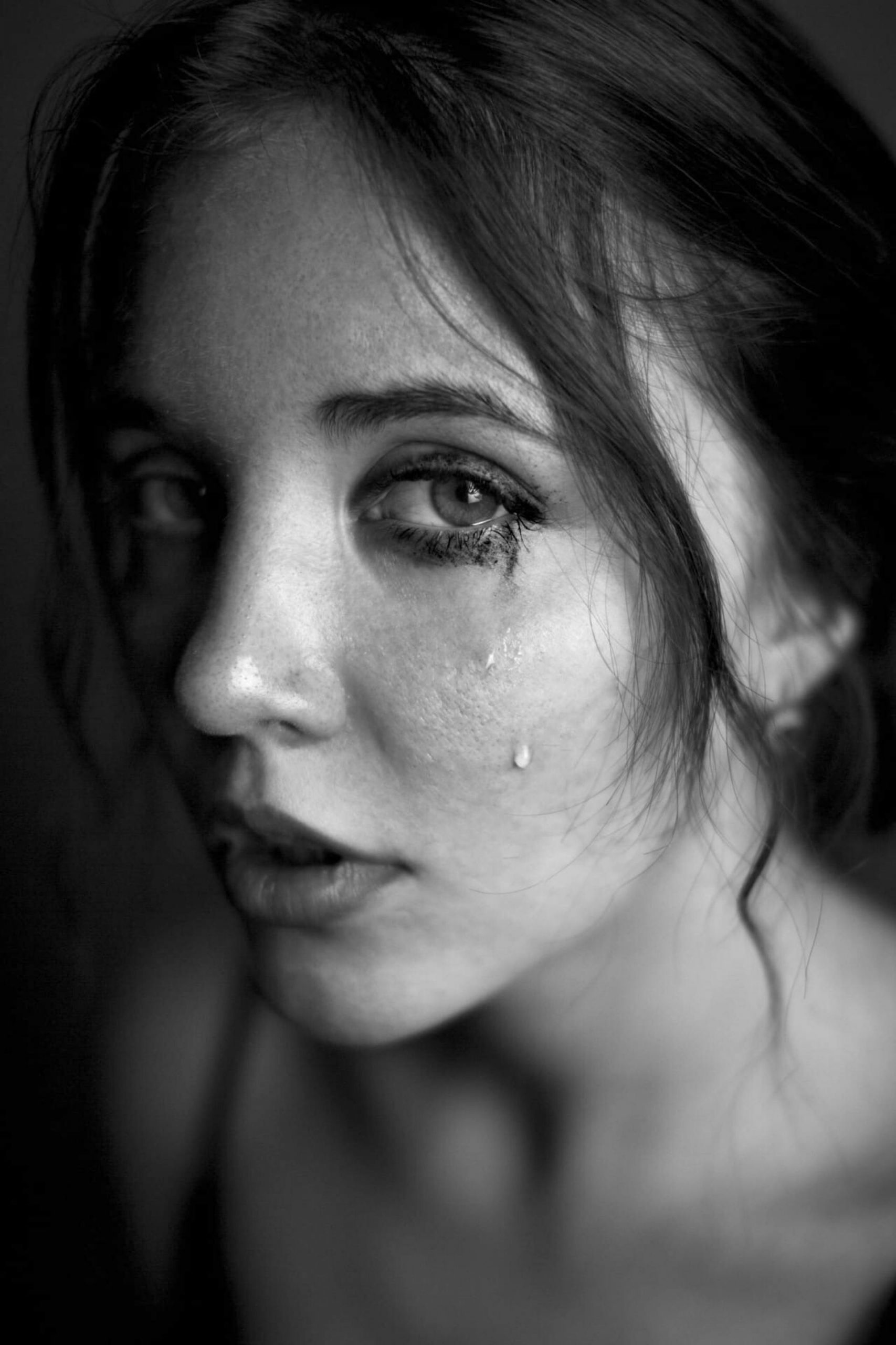 A grayscale photo of a teary-eyed woman | Source: Pexels