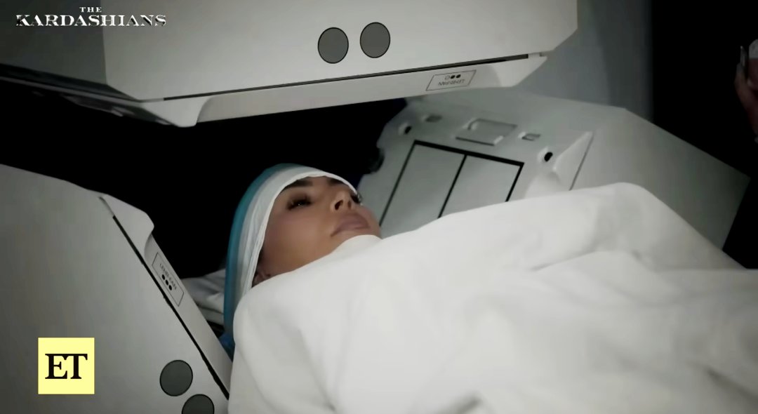 Kim Kardashian lies inside a medical scanner during a scene from
