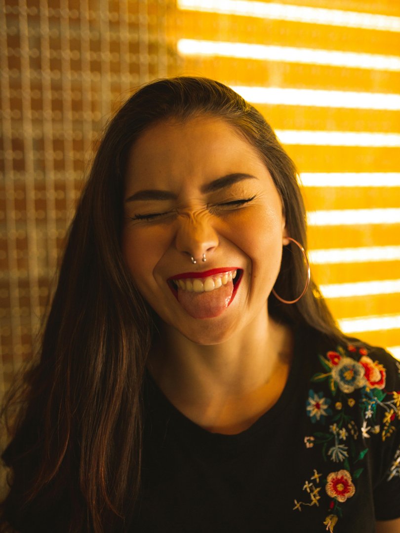 A woman laughing with her tongue out | Source: Pexels