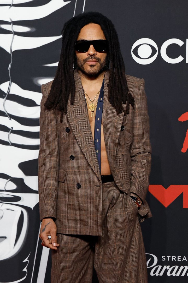 Kravitz, now 61, brought a smoldering sense of style to the 2025 MTV Video Music Awards, stepping onto the red carpet in a sharp brown suit worn without a shirt, layered gold chains, oversized sunglasses, and his signature locs flowing past his shoulders. His look was bold, modern, and effortlessly cool — a testament to how rock star edge can evolve with age without losing its bite.