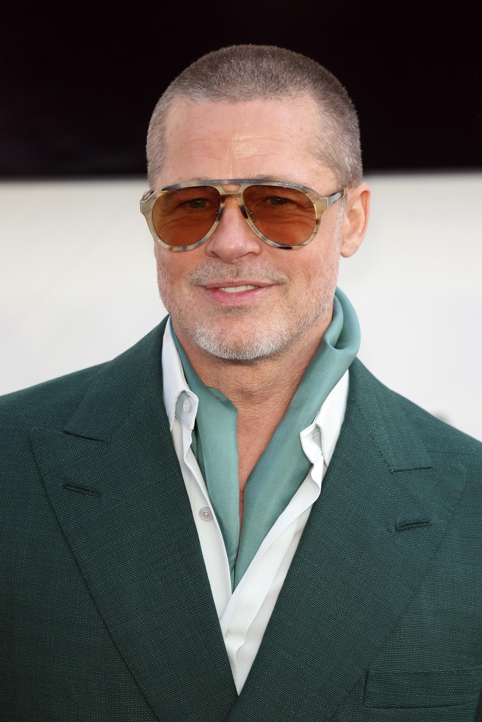Just a week later in London, Pitt pivoted with a fashion-forward twist, pairing a deep green suit with a silk scarf tucked neatly beneath an open collar and oversized amber shades. It was confident, cinematic, and unmistakably modern — the kind of style evolution that felt less like reinvention and more like effortless acceleration.