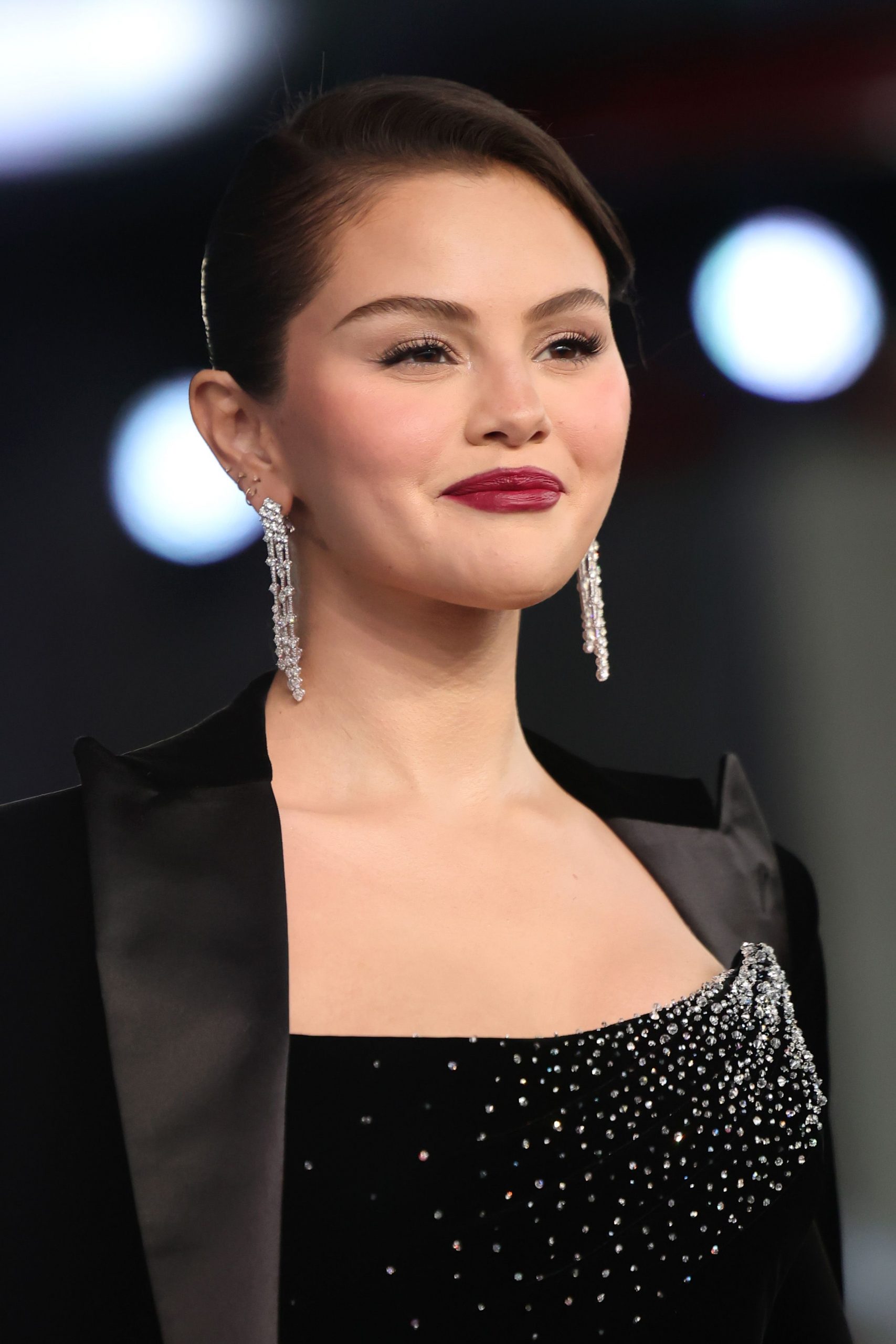 Gomez, now 33, arrived at the 2025 Academy Museum Gala in Los Angeles with classic Hollywood elegance. Wearing a black velvet gown embellished with cascading crystals and dramatic drop earrings, she looked poised and polished. Her sleek updo and deep berry lipstick added a timeless finish to a look that felt both glamorous and contemporary.
