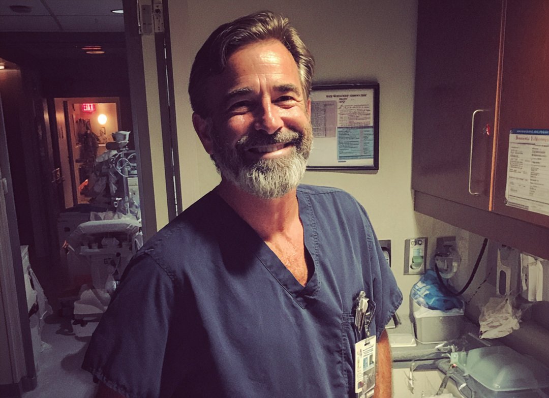 A smiling doctor wearing scrubs | Source: Midjourney