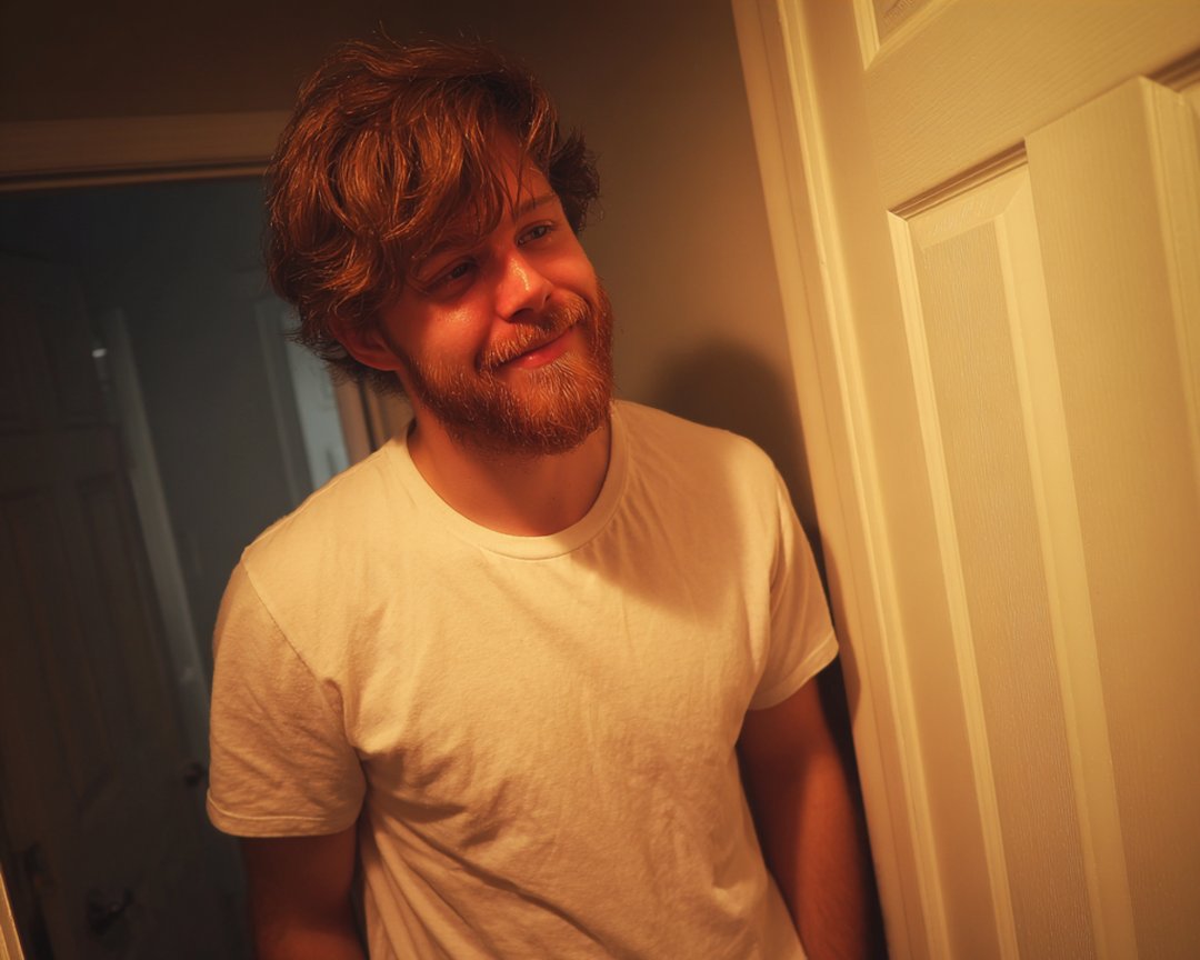 A smiling man standing in a doorway | Source: Midjourney