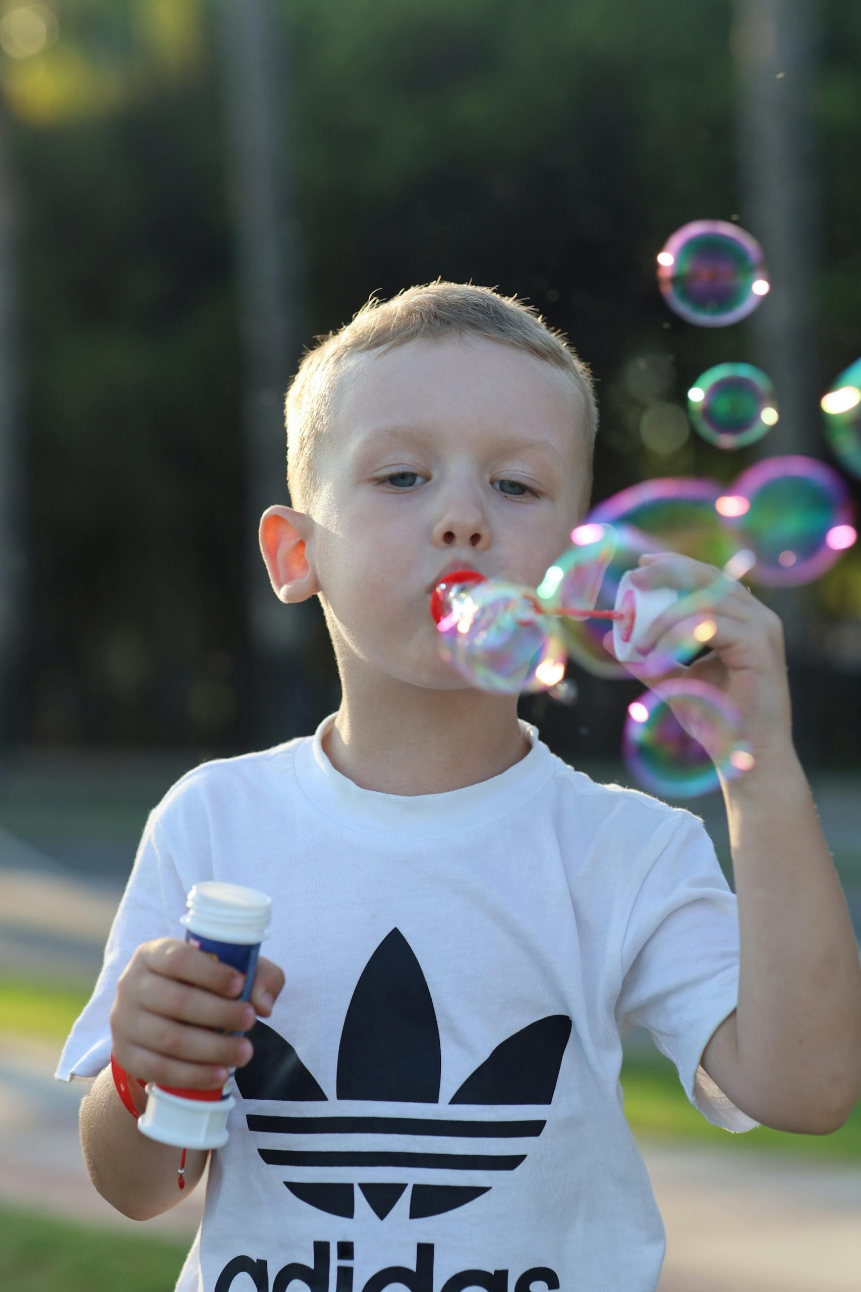 A boy blowing bubbles | Source: Pexels