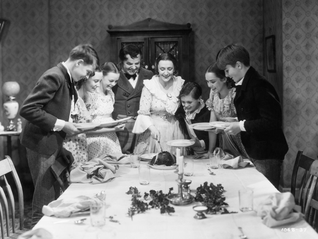 The Cratchit family at Christmas dinner in a scene from