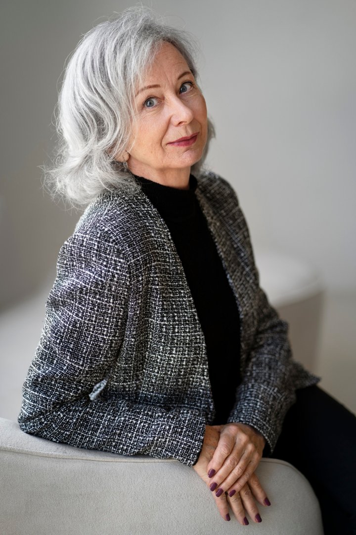 An elegant senior woman sitting on the couch | Source: Freepik