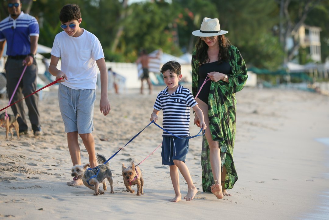 Lauren Silverman walks with her sons Adam and Eric on the beach in Bridgetown, Barbados, on December 20, 2019 | Source: Getty Images