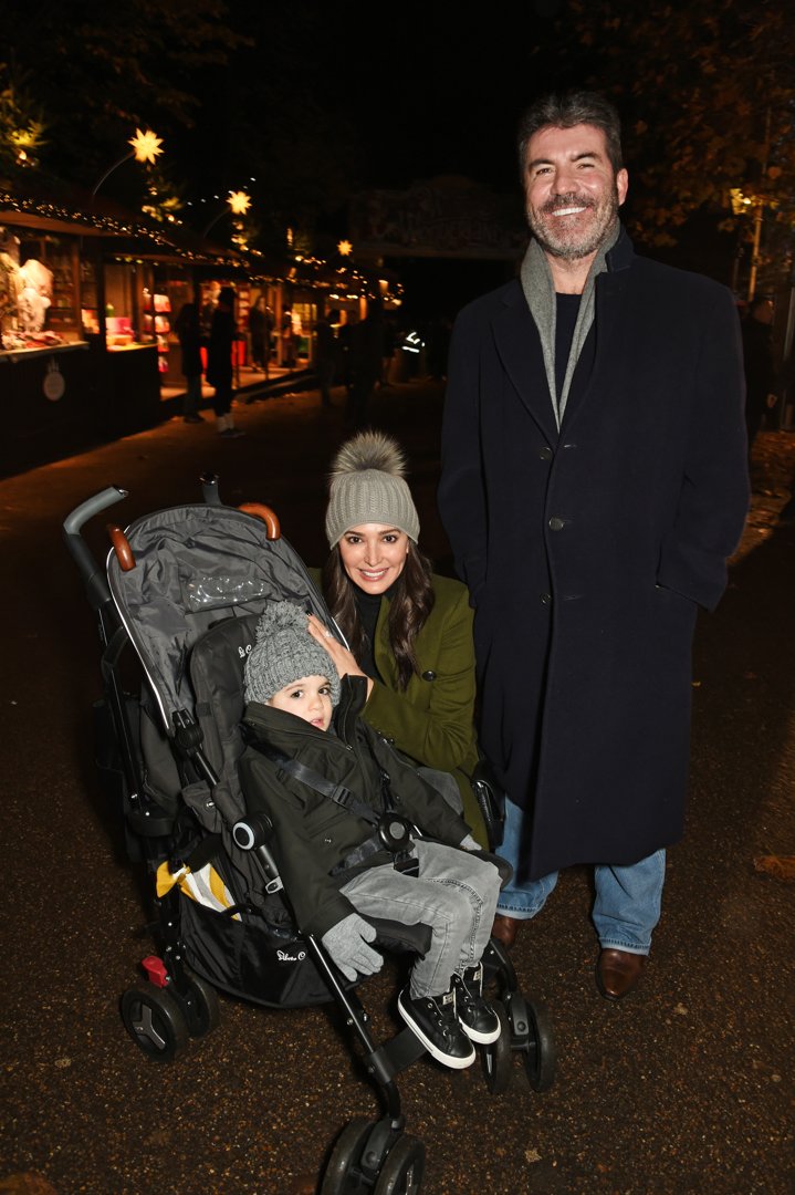 Eric and Simon Cowell with Lauren Silverman at Hyde Park Winter Wonderland on November 17, 2016, in London, England | Source: Getty Images