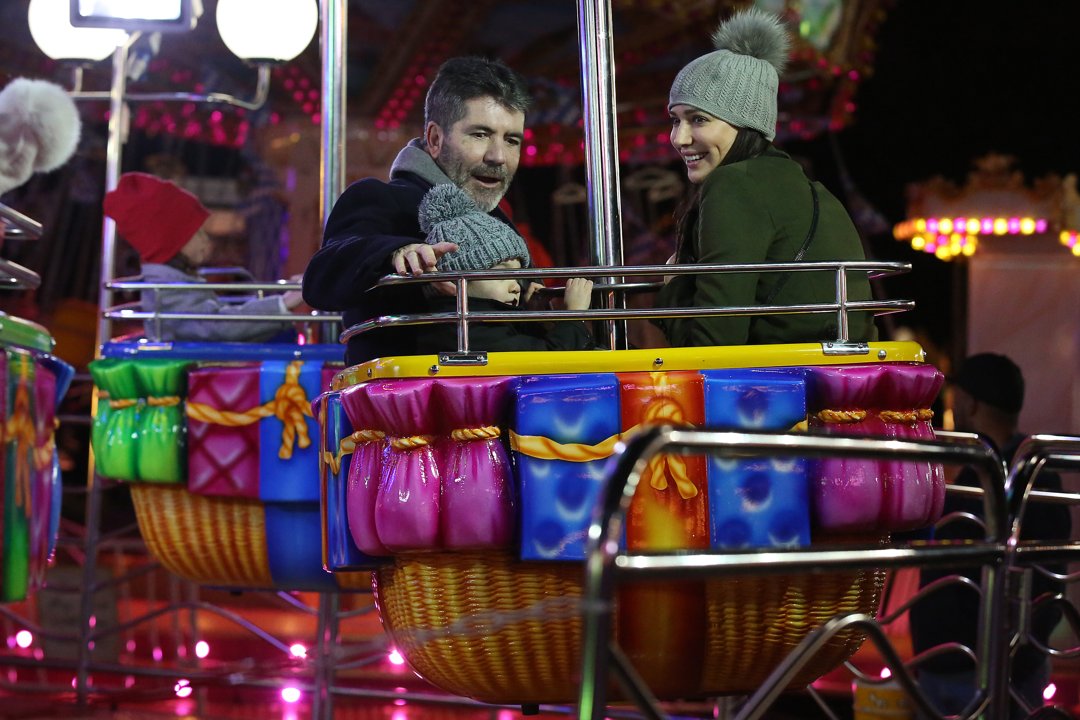 Eric and Simon Cowell with Lauren Silverman at Hyde Park Winter Wonderland on November 17, 2016, in London, England | Source: Getty Images