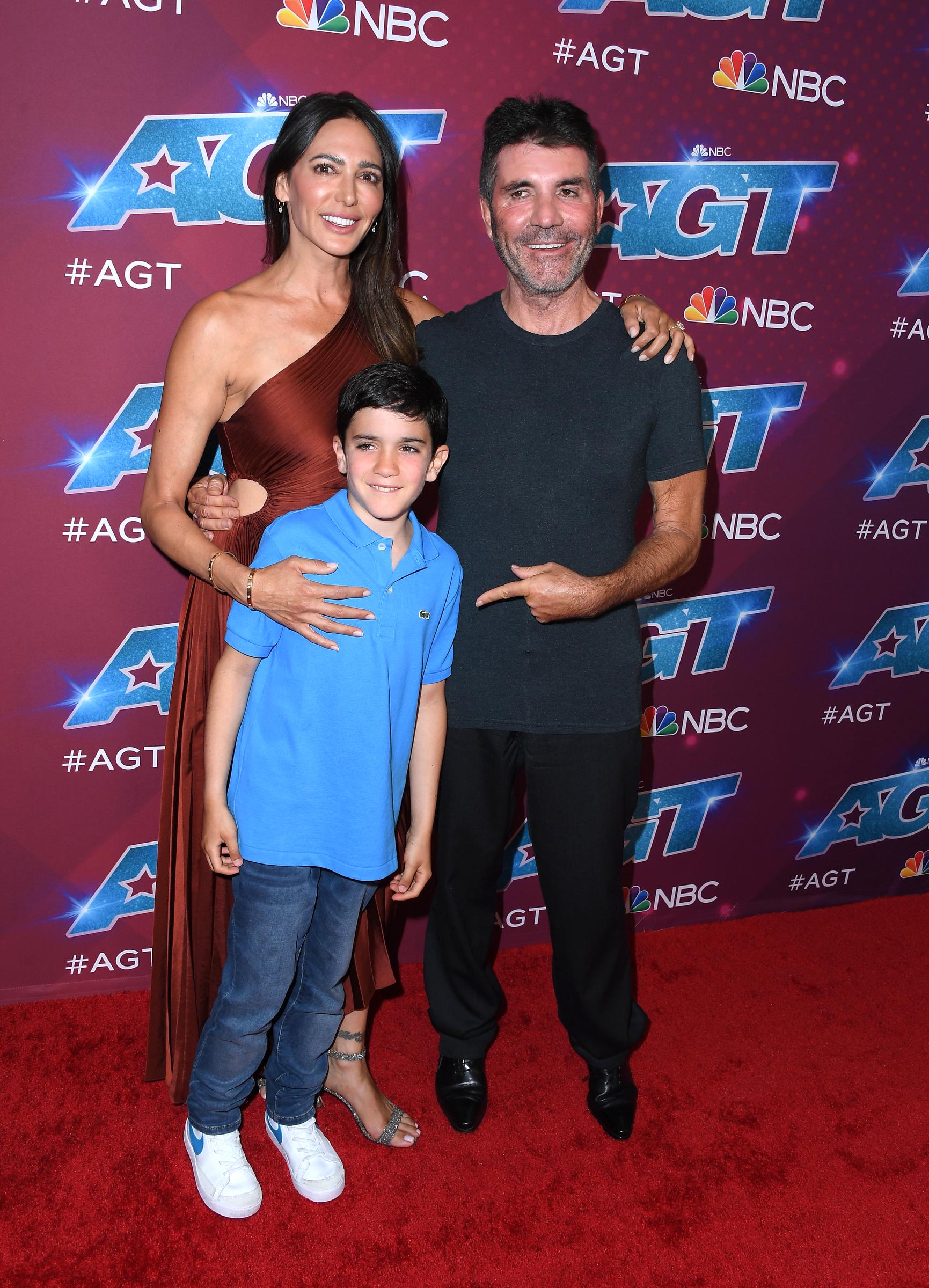 Lauren Silverman with Eric and Simon Cowell at the red carpet for