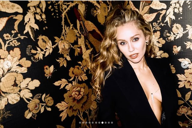 Miley Cyrus poses confidently against an ornate floral backdrop, as seen from her post dated October 25, 2025 | Source: Instagram/mileycyrus