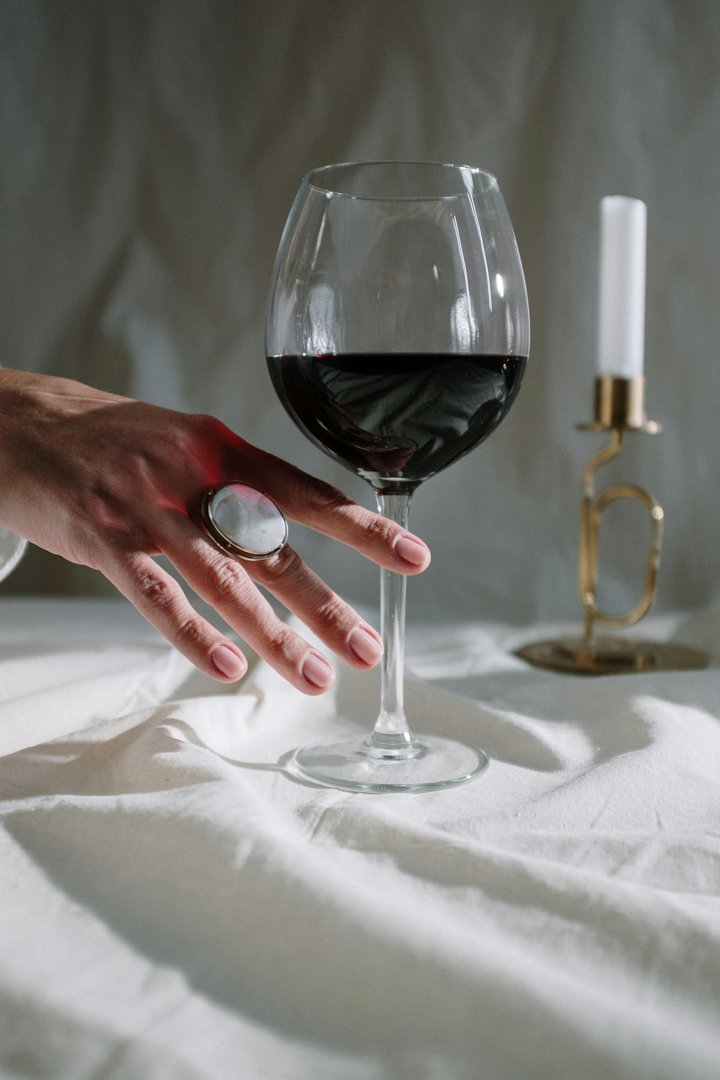 A glass of wine on a table | Source: Pexels