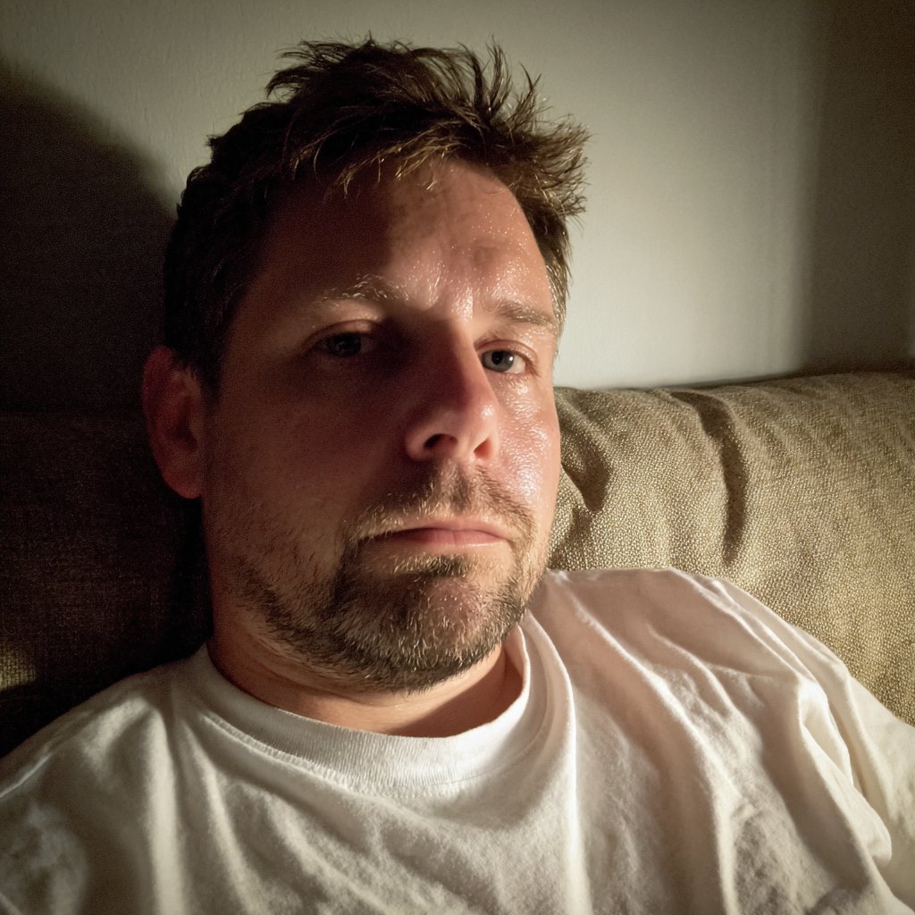 A man sitting on a couch | Source: Midjourney