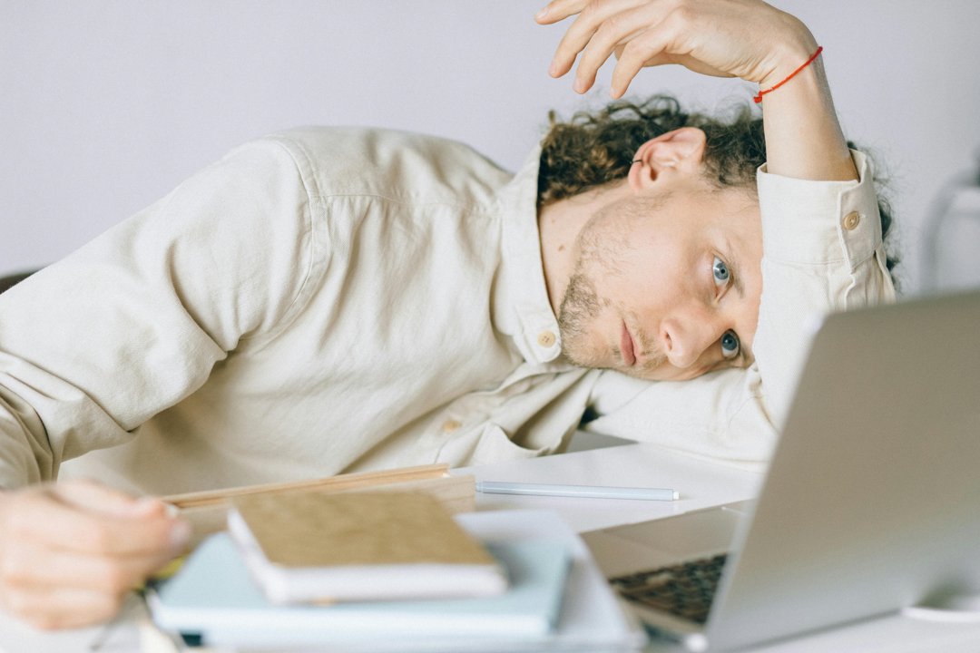 A stressed and exhausted man at work | Source: Pexels