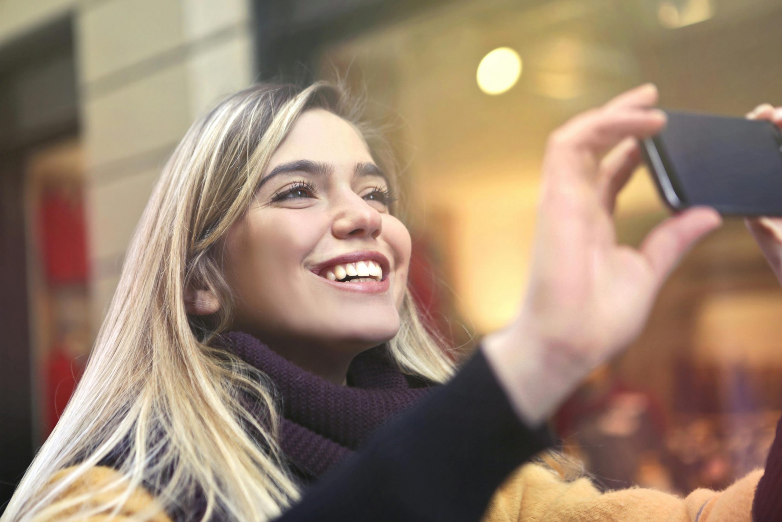 A woman holding up her phone to record something | Source: Pexels