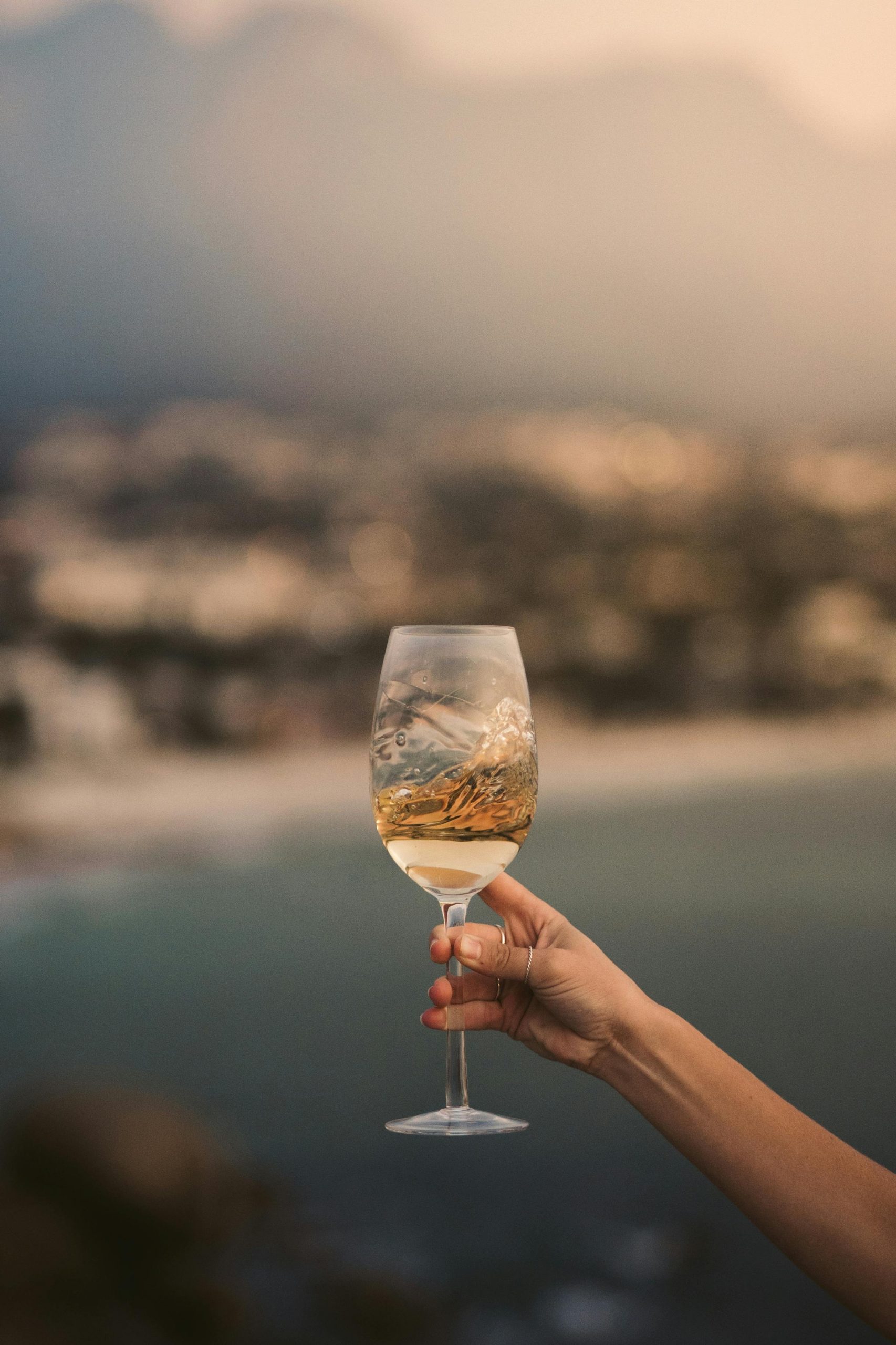 A woman's hand holding out a glass of champagne | Source: Pexels