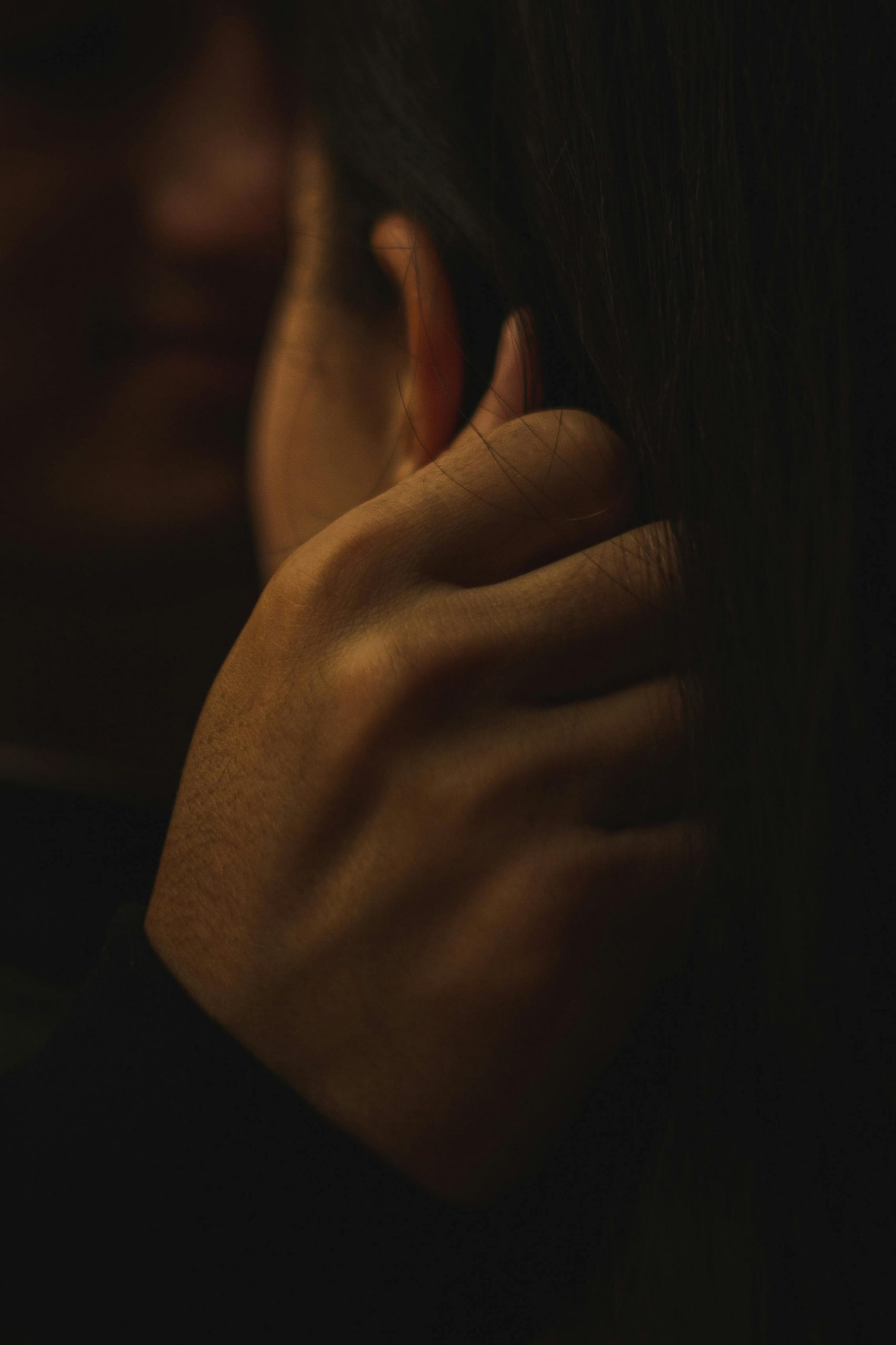 A man touching a woman's ear | Source: Pexels