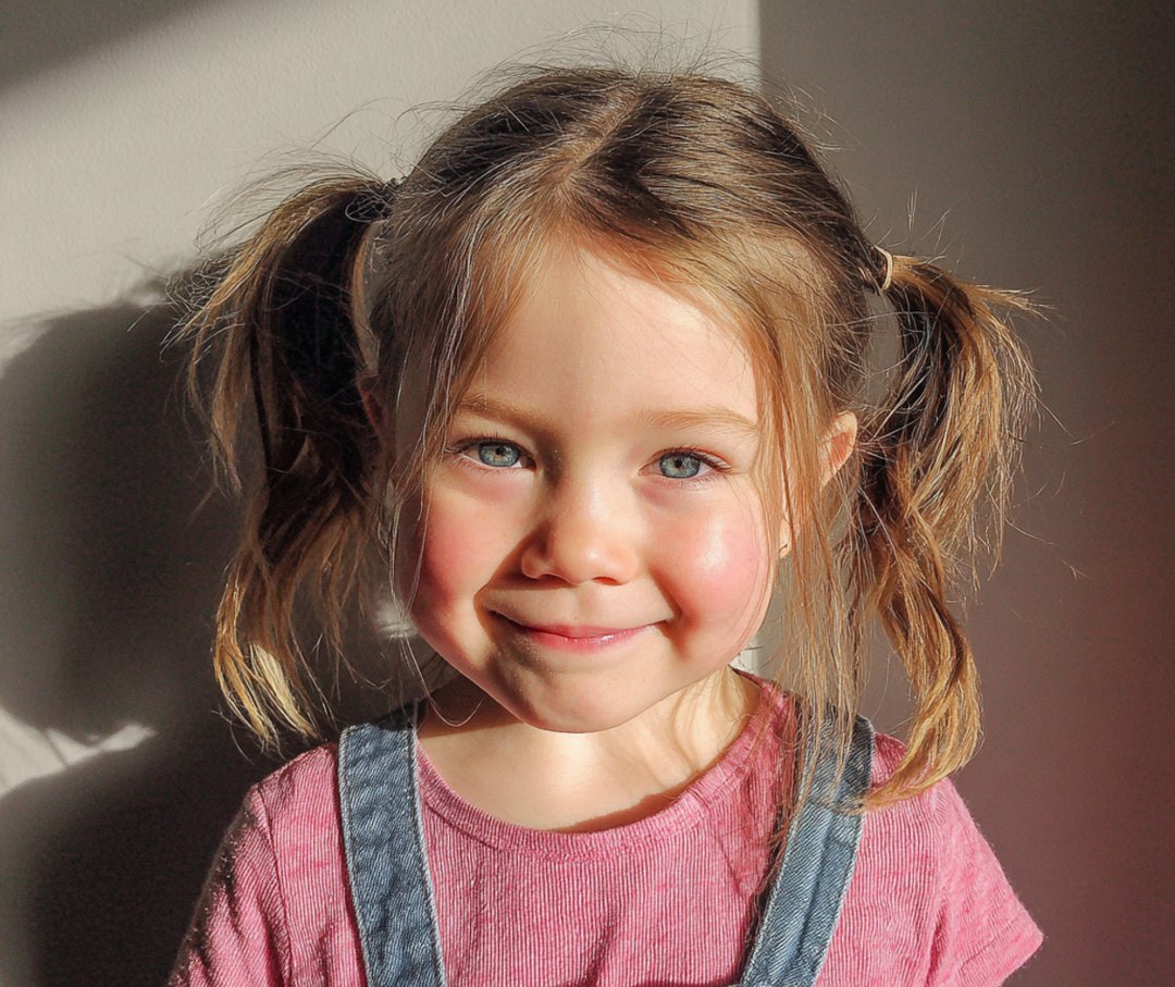 A smiling little girl | Source: Midjourney