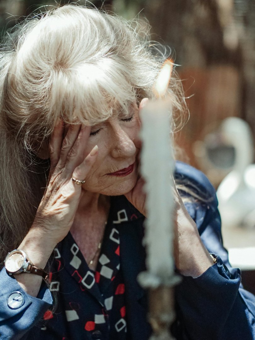 Senior woman with hands on her face | Source: Pexels