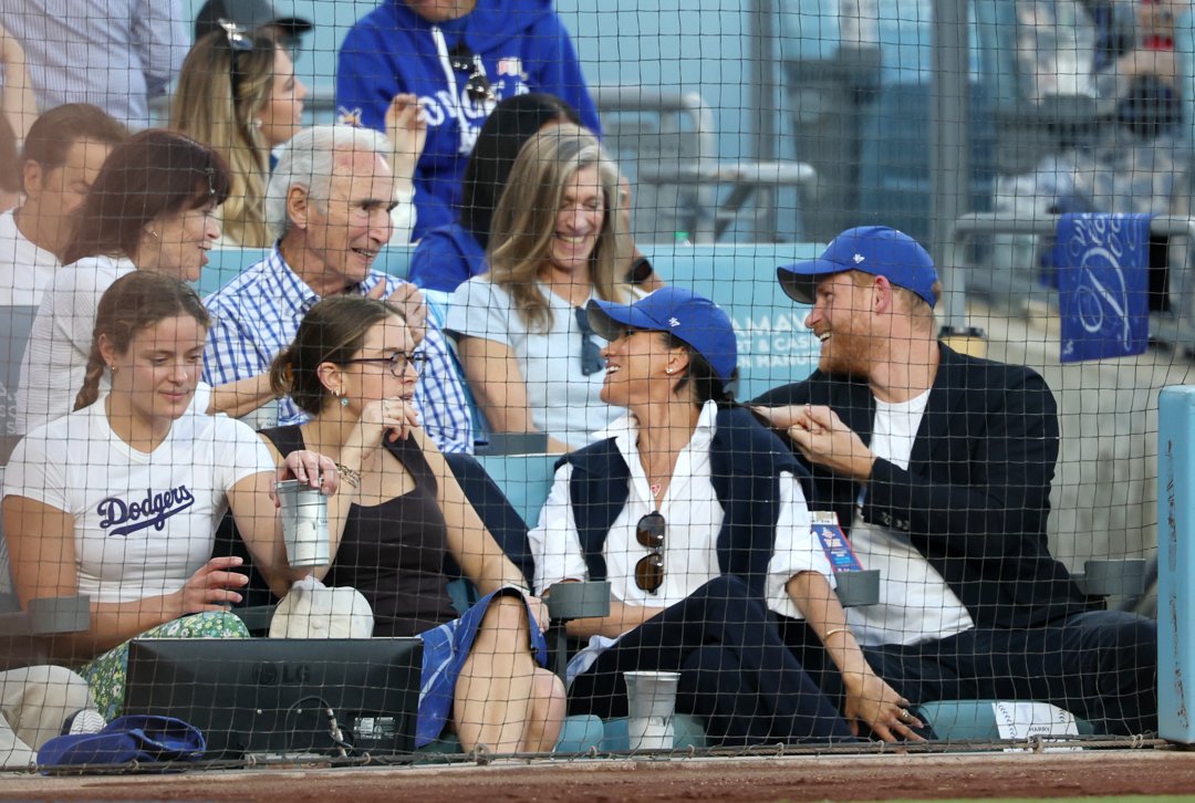 Prince Harry and Meghan Markle, the Duke and Duchess of Sussex, sit in front of Dodger legend Sandy Koufax as they watch Game four of the World Series between the Los Angeles Dodgers and the Toronto Blue Jays | Source: Getty Images