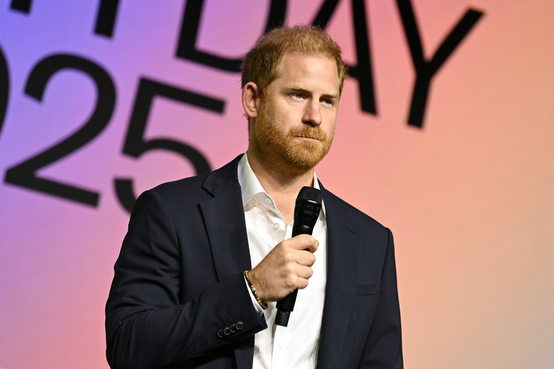 Prince Harry looks on while standing on stage. | Source: Getty Images