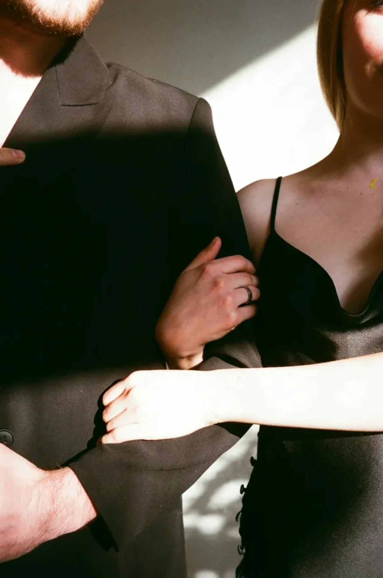 A woman holding a man's arms | Source: Pexels