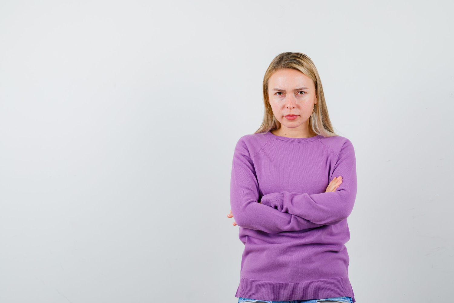 A woman with a serious expression | Source: Freepik