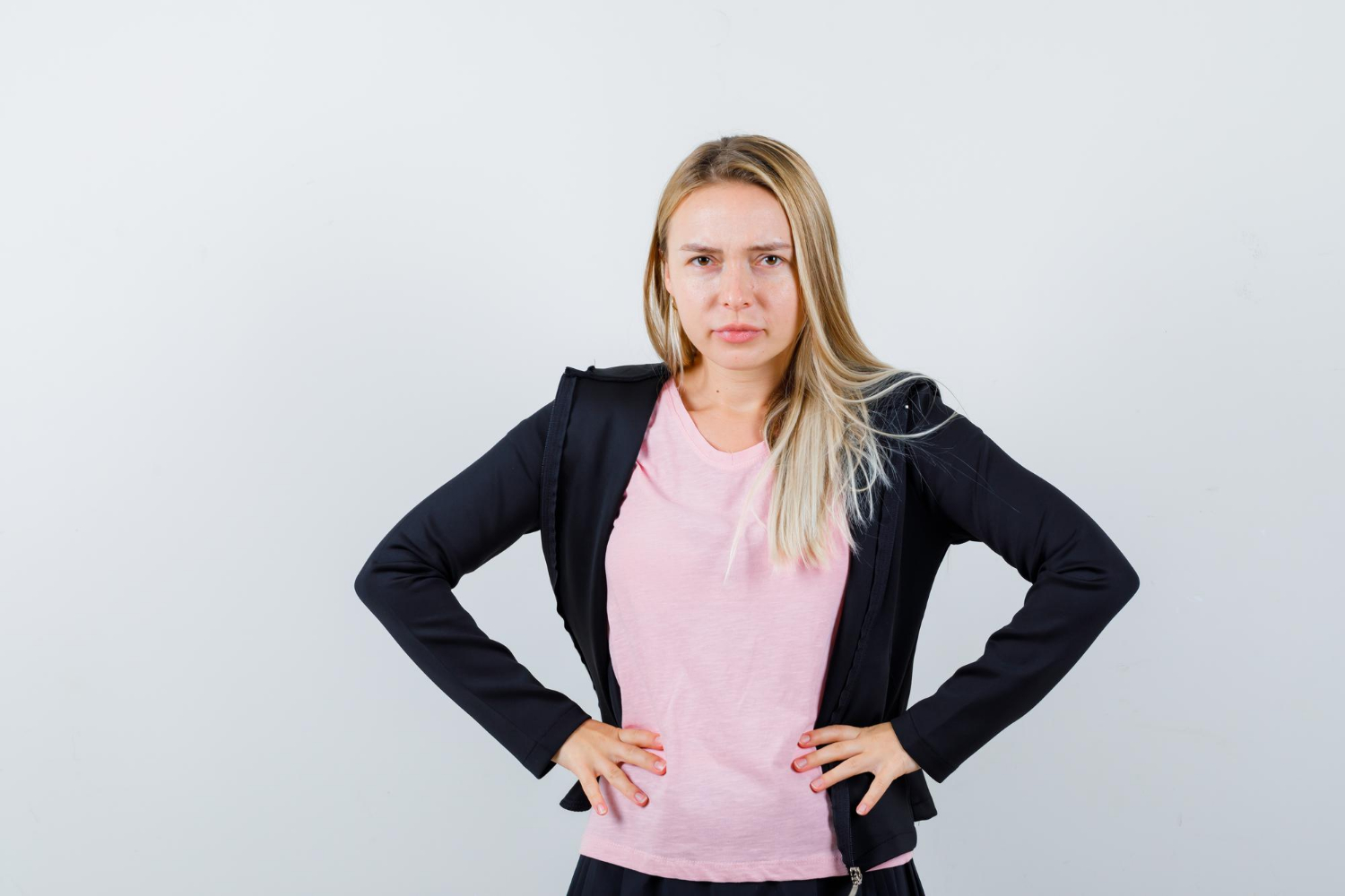 An annoyed woman with her hands on her hip | Source: Freepik