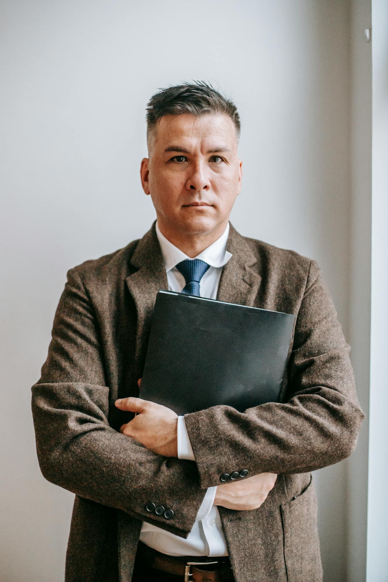 A man holding a file | Source: Pexels