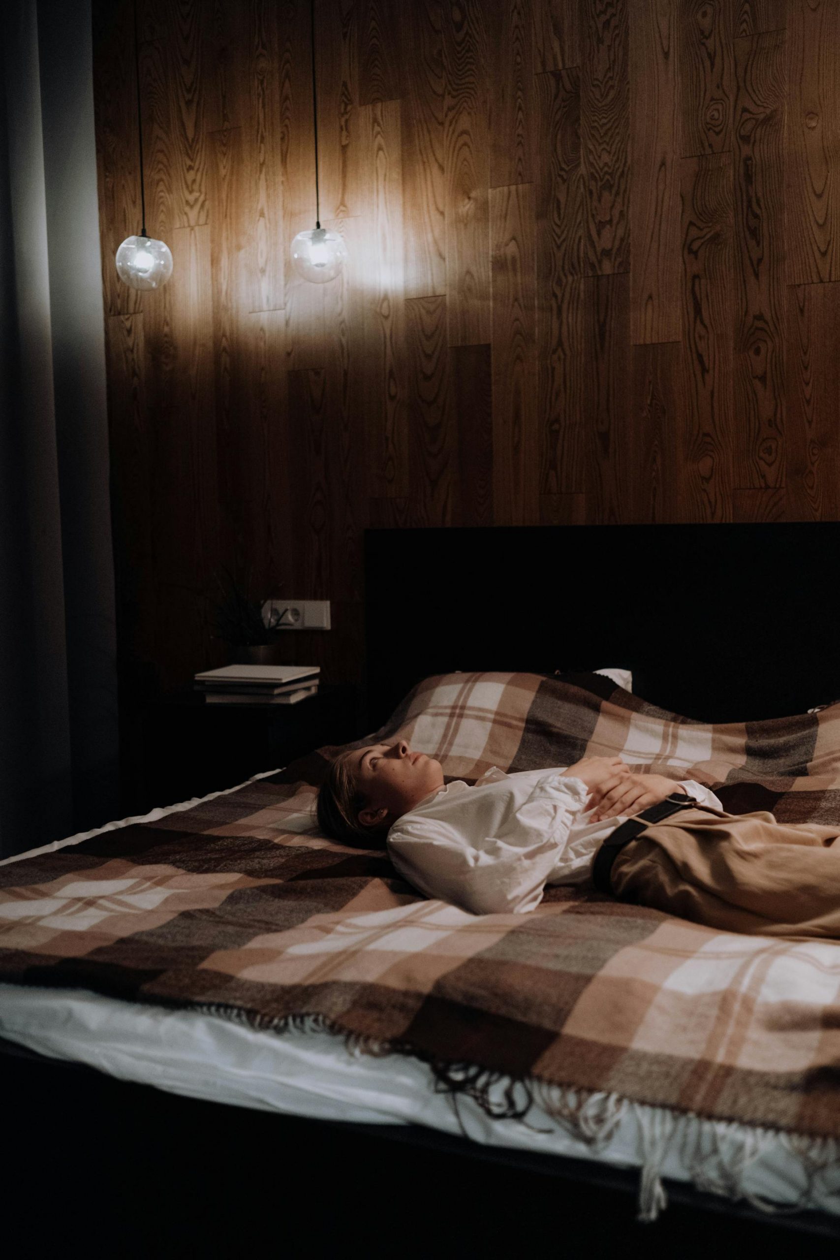 A depressed woman lying on the bed | Source: Pexels