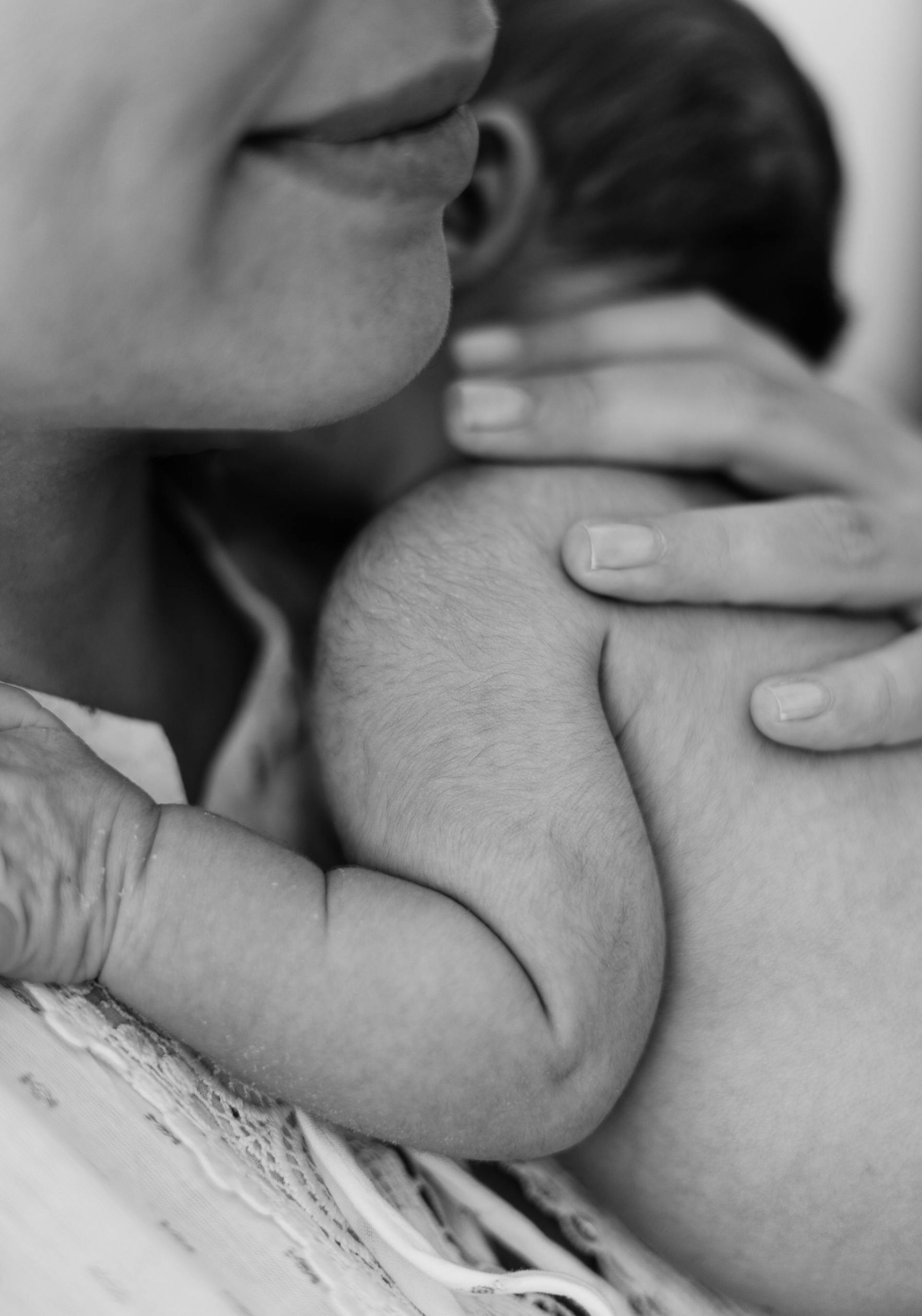 Grayscale photo of a mother holding her newborn baby | Source: Pexels