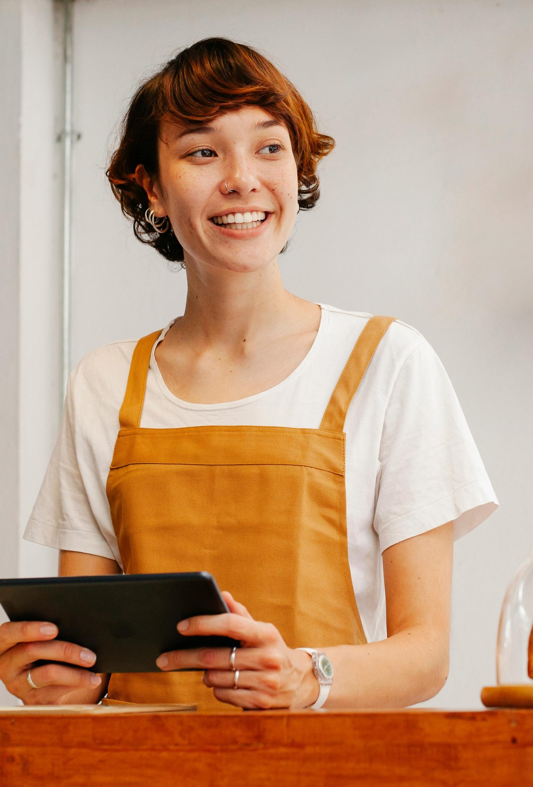 A waitress smiling awkwardly at work | Source: Pexels